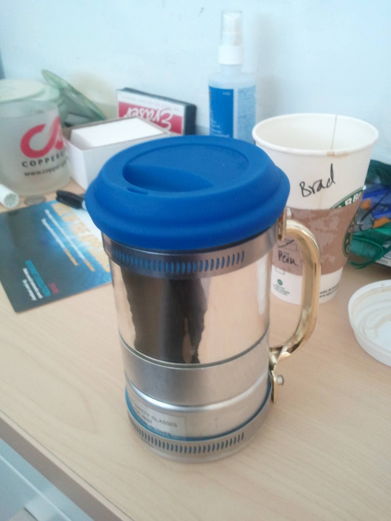 Steinwielder Brad's 350ml Shiny Brass w/ Silicon Lid & "Devil's Coffee" in the Background